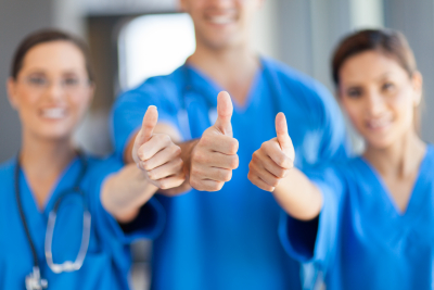 three medical staff thumbs up